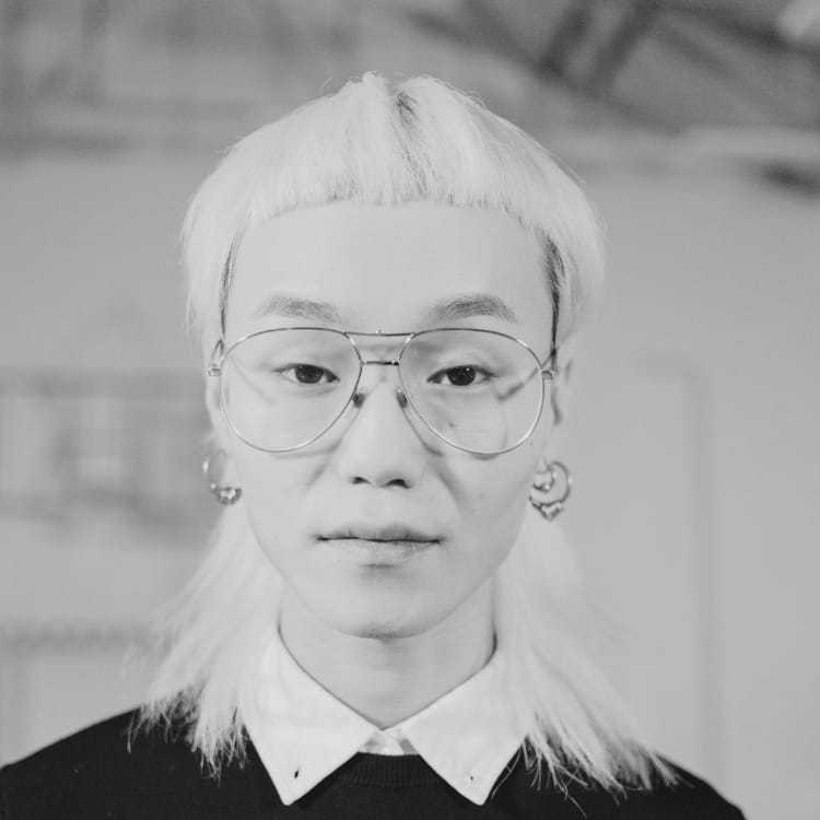 Portrait of Kai, a professional stylist at Jubi Salon, showcasing their expertise and style.